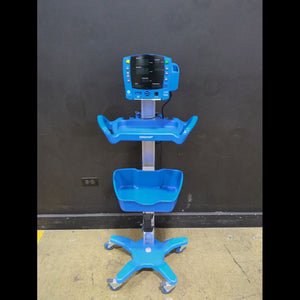 GE CRITIKON DINAMAP CARESCAPE V100 VITAL SIGNS MONITOR ON ROLLING STAND W/ 2 BASKETS & CUFF BIN